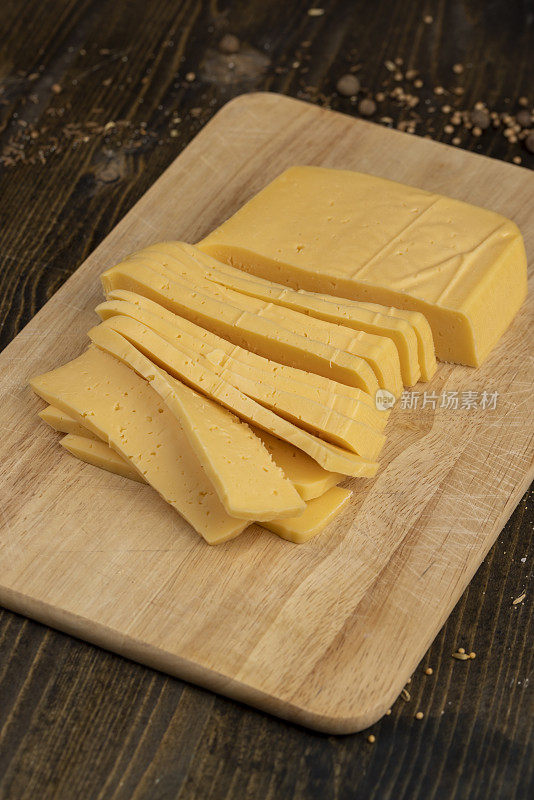 semi- hard cheese with holes cut into chunks
